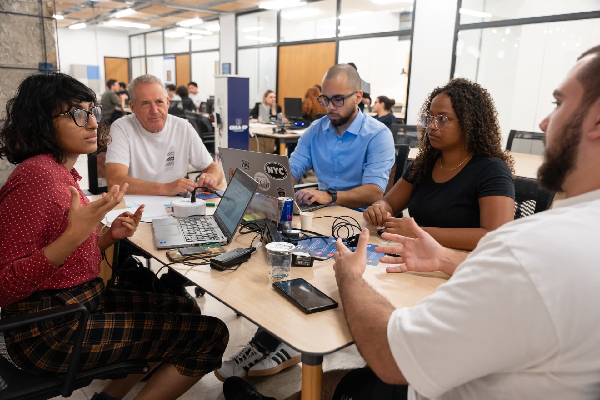 Equipes trabalhando durante um hackathon da Voa Inovação